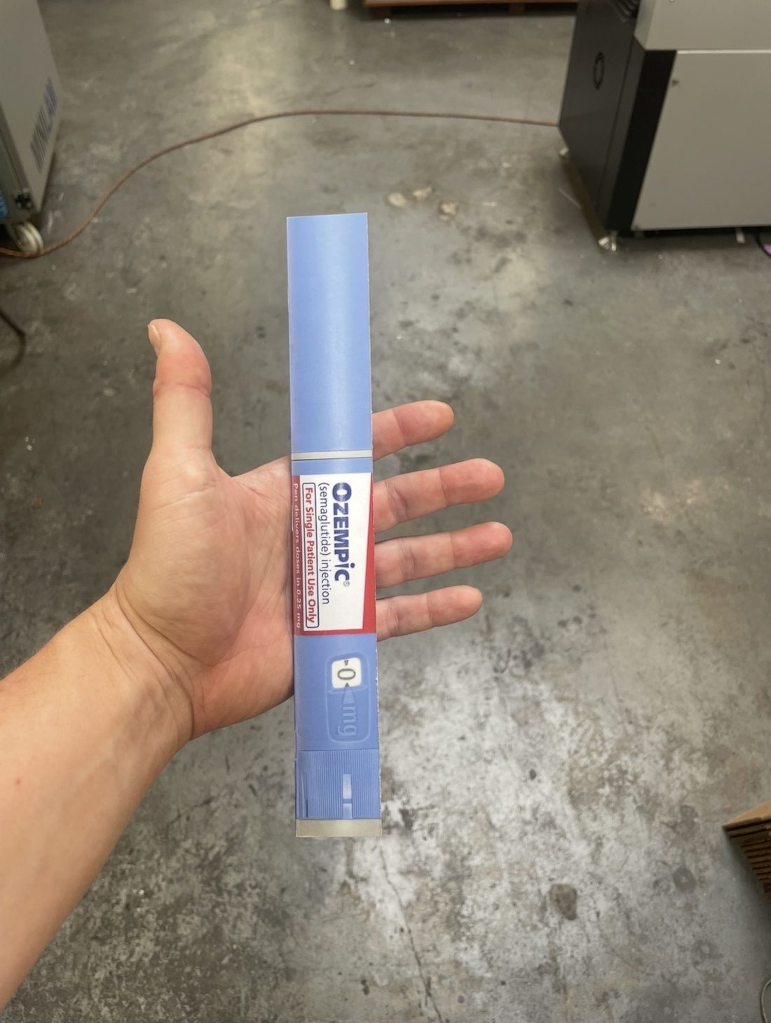 Matt Adam Skinny series, oversized Ozempic pen prop held in hand